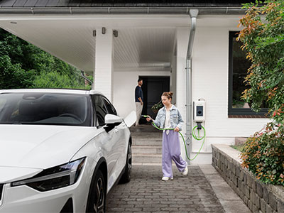 Mädchen steht neben E-Auto