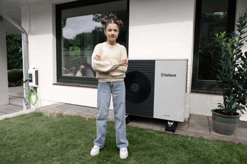 Mädchen steht vor Wärmepumpe
